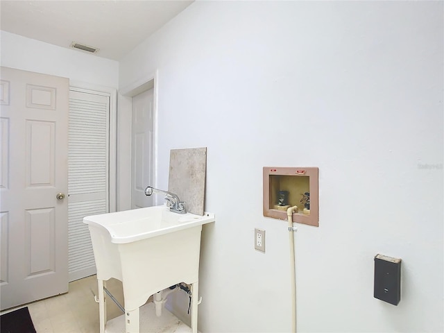 bathroom with visible vents and a sink