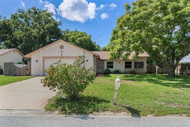 ranch-style house with an attached garage, driveway, a front yard, and fence