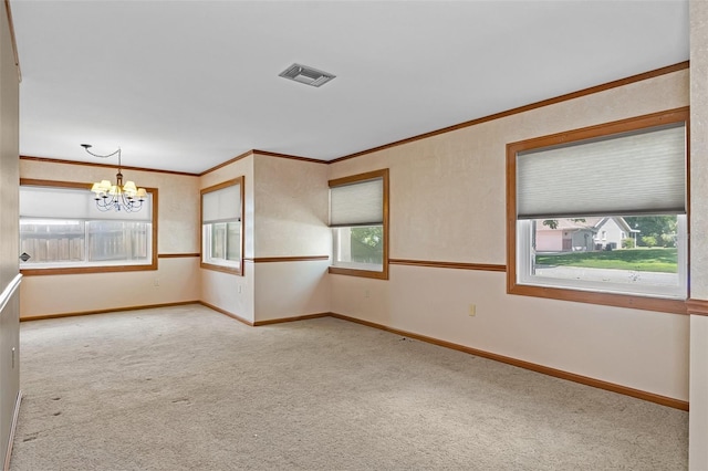 empty room with visible vents, carpet floors, a chandelier, and ornamental molding