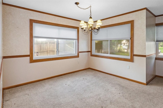 unfurnished room featuring baseboards, carpet floors, a notable chandelier, and ornamental molding