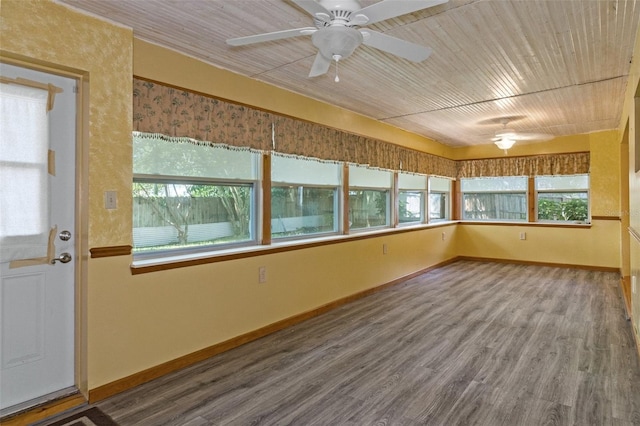 unfurnished sunroom featuring wooden ceiling and a ceiling fan