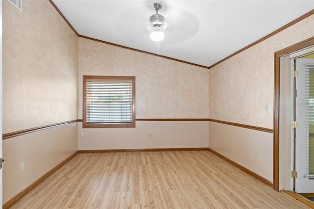 spare room featuring crown molding, light wood-style flooring, baseboards, and visible vents