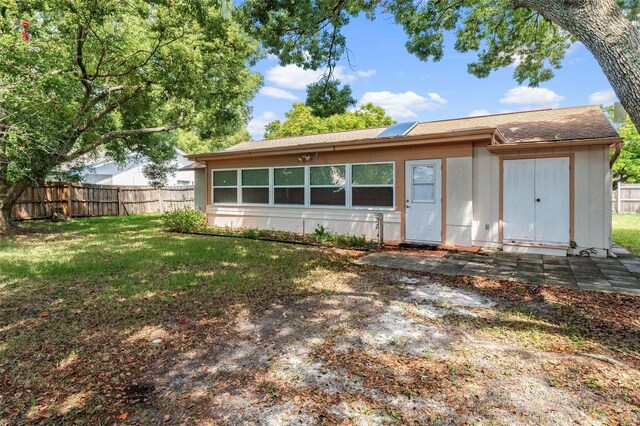 view of front of home with a front lawn and fence