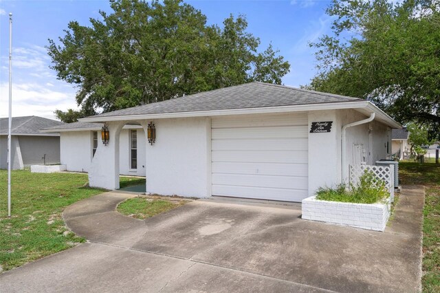 single story home featuring a front yard and a garage