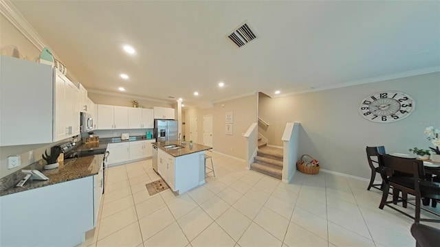 kitchen featuring a center island with sink, appliances with stainless steel finishes, ornamental molding, sink, and white cabinetry