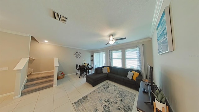 living room featuring ceiling fan, light tile patterned floors, crown molding, and a textured ceiling