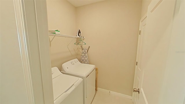 31941 Blue Passing Loop, Wesley Chapel, FL 33545 - washroom featuring separate washer and dryer, tile patterned floors, and baseboards