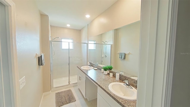 31941 Blue Passing Loop, Wesley Chapel, FL 33545 - bathroom with a shower stall, tile patterned floors, double vanity, baseboards, and recessed lighting
