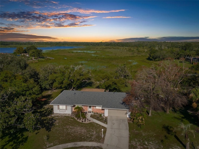 aerial view at dusk with a water view