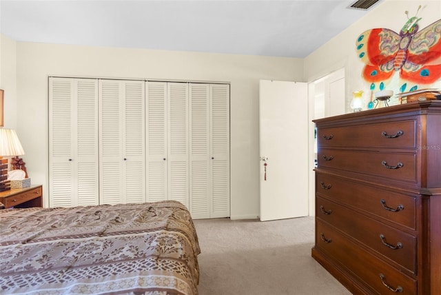 bedroom featuring a closet and light colored carpet