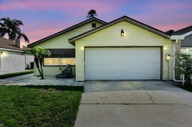 view of front of house featuring cooling unit and a garage