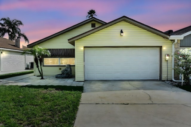 exterior space featuring a garage, concrete driveway, and central AC unit