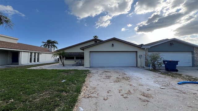 single story home featuring a front yard and a garage