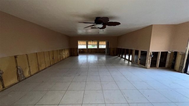 unfurnished room with wood walls and ceiling fan