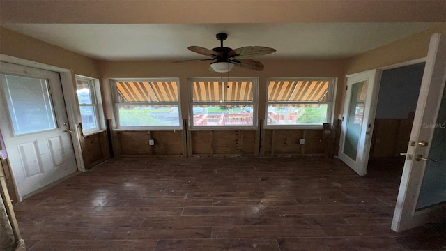 unfurnished sunroom featuring ceiling fan