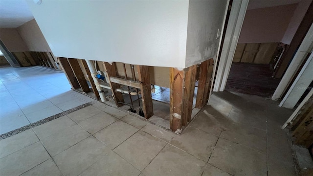 stairway featuring tile patterned flooring