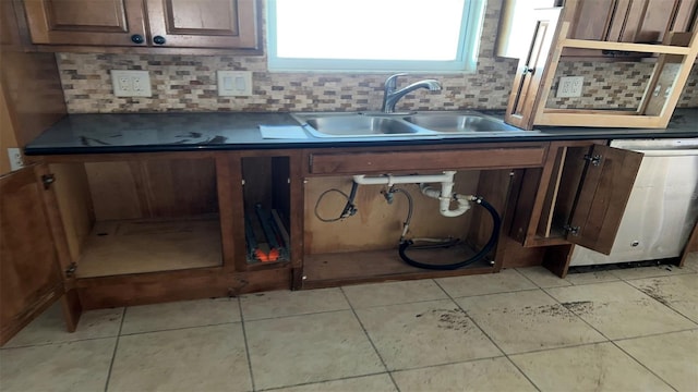 kitchen with sink, dishwasher, dark brown cabinetry, decorative backsplash, and light tile patterned floors