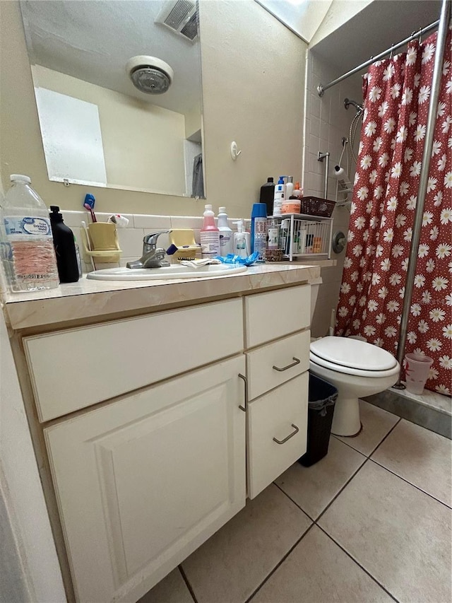 bathroom featuring a shower with curtain, vanity, toilet, and tile patterned floors