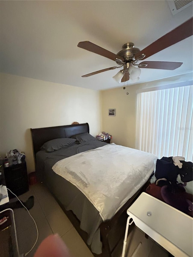 tiled bedroom with ceiling fan