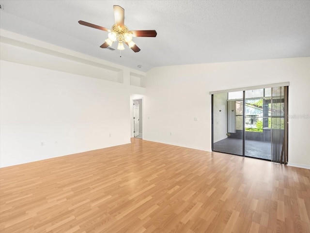 spare room featuring a textured ceiling, high vaulted ceiling, ceiling fan, and light hardwood / wood-style flooring