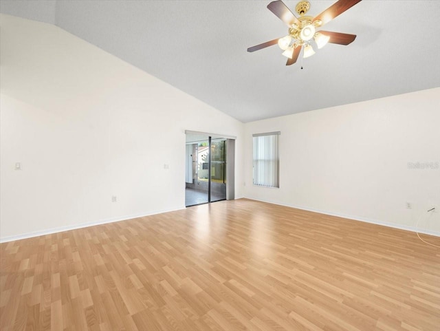 spare room with light hardwood / wood-style floors, vaulted ceiling, and ceiling fan