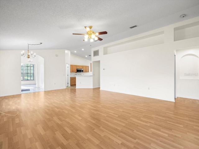 unfurnished living room featuring a textured ceiling, ceiling fan with notable chandelier, light hardwood / wood-style floors, and high vaulted ceiling