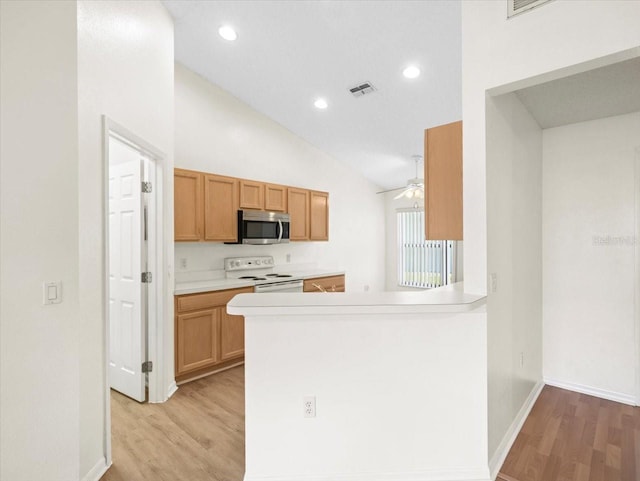 kitchen with ceiling fan, white electric range, light hardwood / wood-style floors, and kitchen peninsula