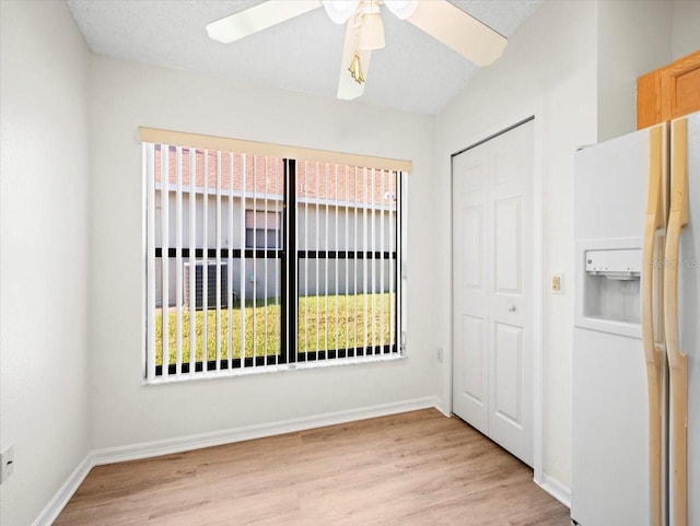 empty room featuring a textured ceiling, ceiling fan, and light hardwood / wood-style flooring