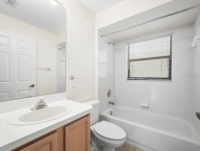 full bathroom with tile patterned flooring, a textured ceiling, tiled shower / bath combo, vanity, and toilet