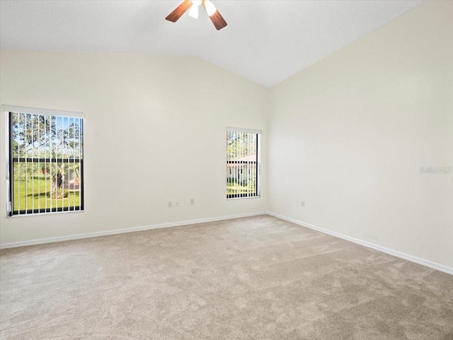 empty room with high vaulted ceiling, ceiling fan, and light colored carpet