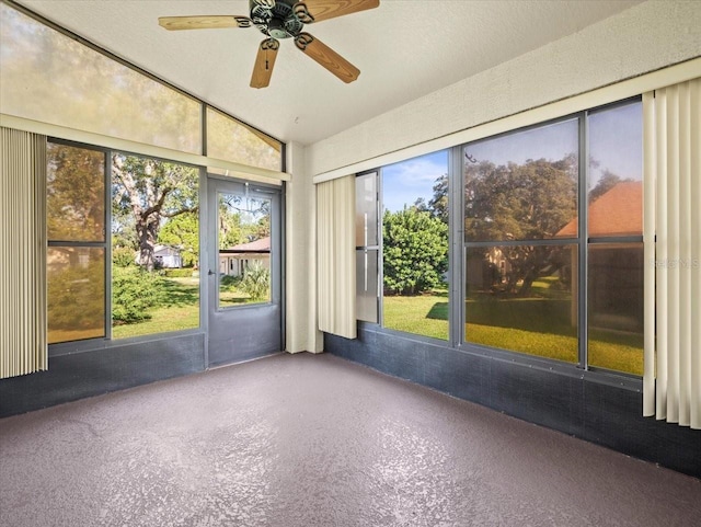 unfurnished sunroom with vaulted ceiling and ceiling fan