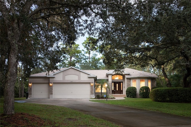 view of front of house featuring a front yard and a garage