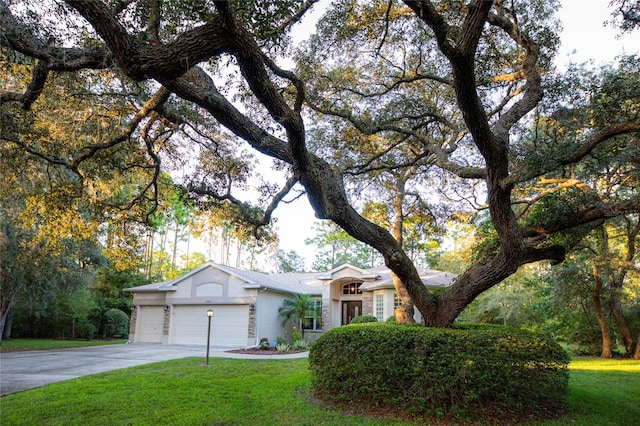 view of front of house featuring a garage and a front lawn