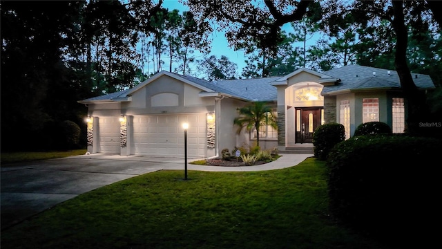 ranch-style house featuring a garage and a front yard