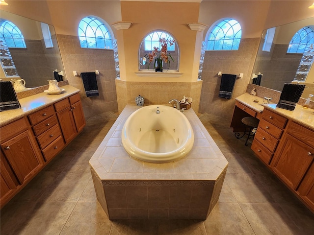 bathroom featuring tile patterned floors, vanity, tile walls, and ornate columns