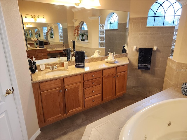 bathroom featuring tile patterned flooring, vanity, and a tub