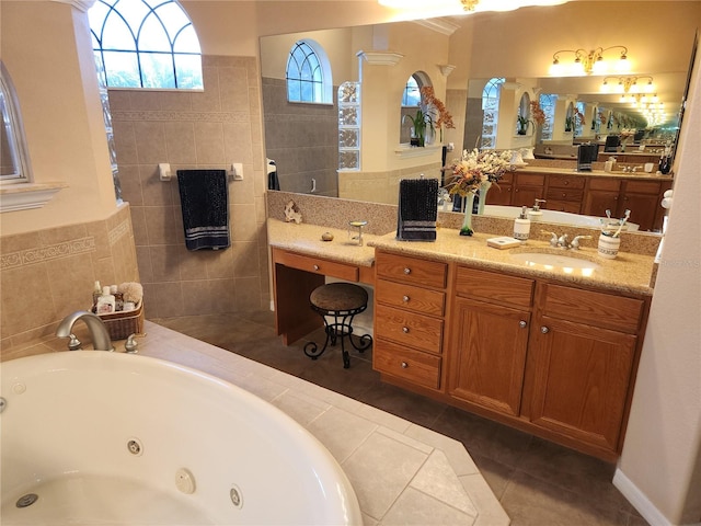 bathroom featuring tile patterned flooring, vanity, tile walls, and a washtub