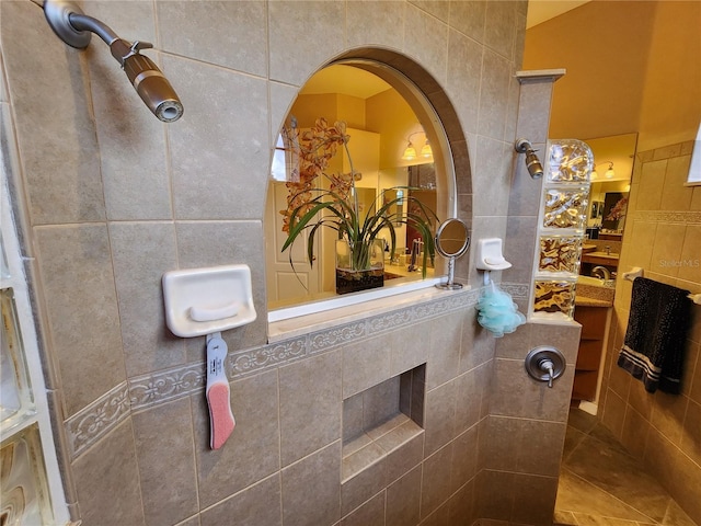 bathroom with vanity, tile walls, and a tile shower