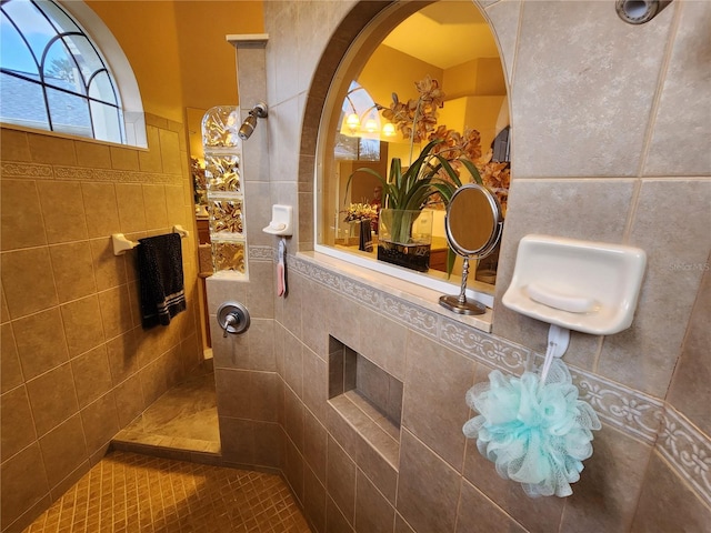 bathroom featuring tiled shower, tile walls, and tile patterned floors