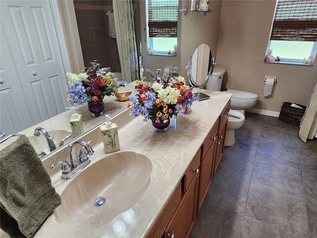 bathroom with tiled shower, tile patterned flooring, toilet, and vanity