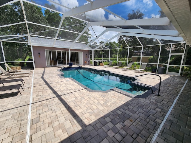 view of pool with a patio and a lanai