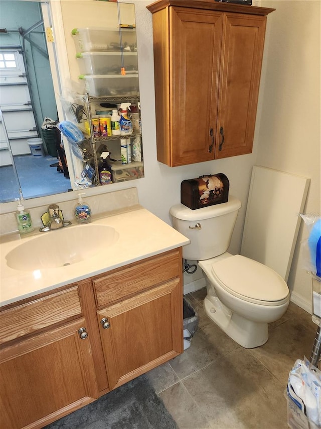 bathroom with tile patterned floors, toilet, and vanity