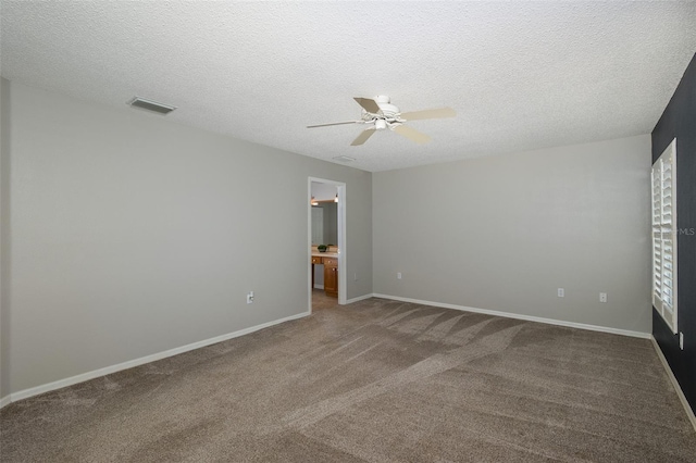 carpeted empty room featuring a textured ceiling and ceiling fan