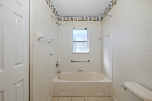 bathroom with a textured ceiling, tile patterned floors, toilet, and shower / bathtub combination