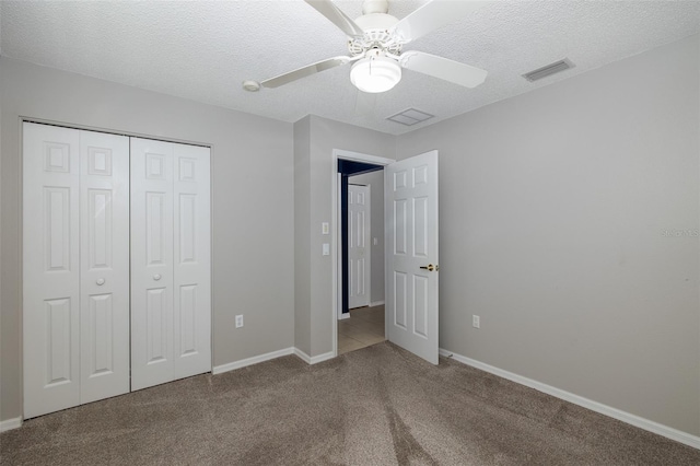 unfurnished bedroom featuring a textured ceiling, carpet flooring, ceiling fan, and a closet