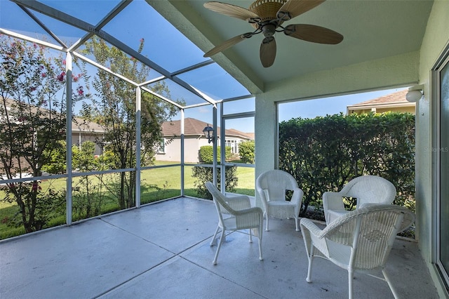 unfurnished sunroom with ceiling fan