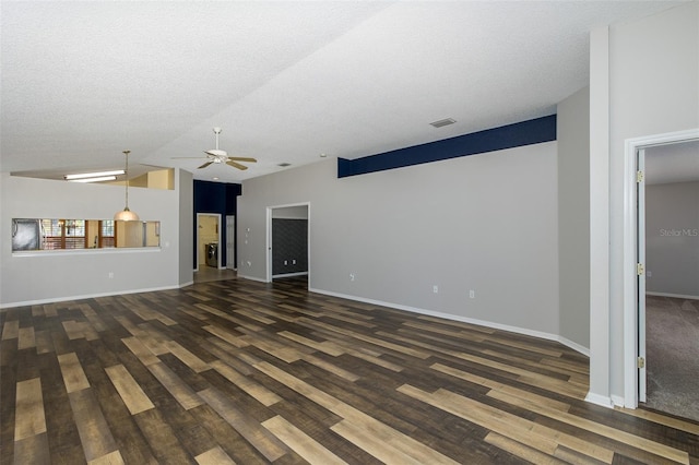 unfurnished living room featuring vaulted ceiling, ceiling fan, dark wood-type flooring, and a textured ceiling