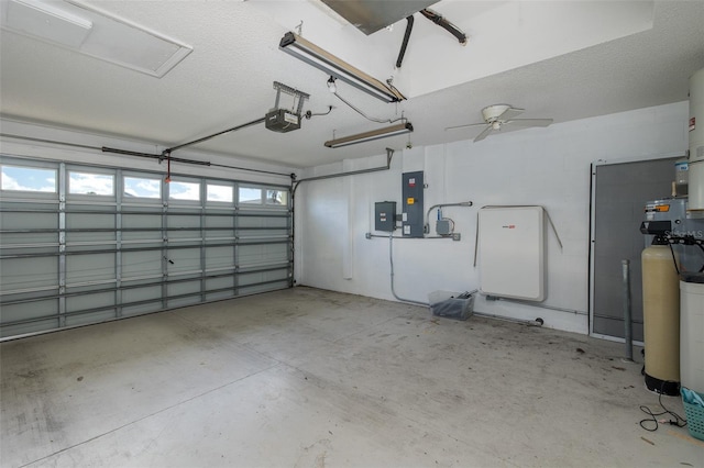 garage featuring a garage door opener, electric panel, and ceiling fan