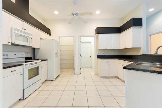 kitchen featuring white appliances, sink, ceiling fan, white cabinets, and light tile patterned flooring