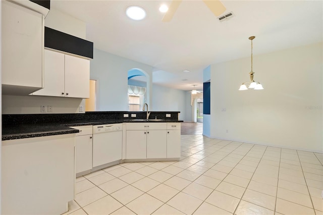 kitchen with white cabinets, a sink, ceiling fan, dishwasher, and a peninsula